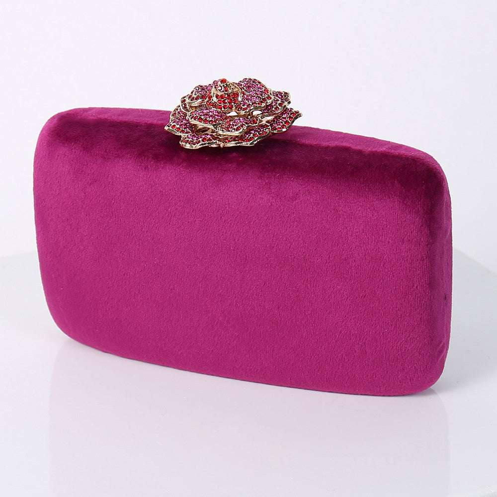 Purple flannel party bag with decorative jeweled floral clasp.