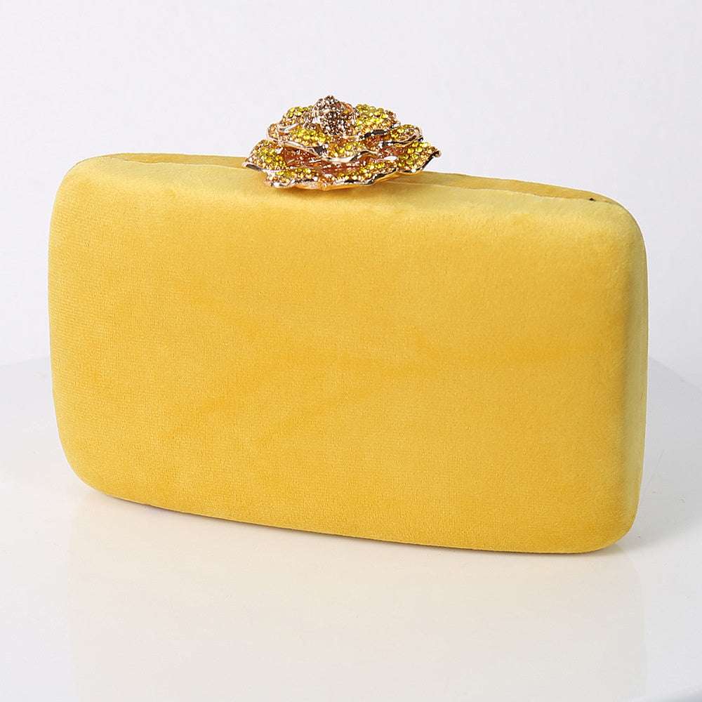 Yellow flannel party bag with gold jeweled floral clasp.