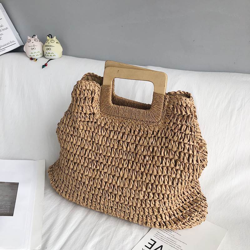 Woven straw beach handbag with textured weave and rectangular square cutout handle