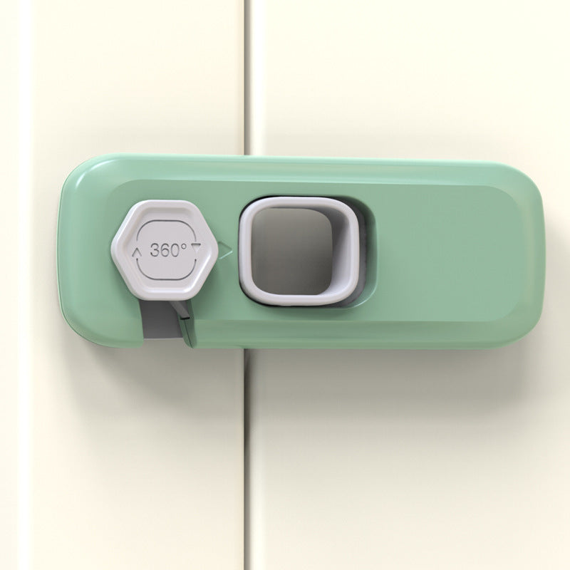 Fridge freezer door lock in mint green mounted on a cabinet door, close-up