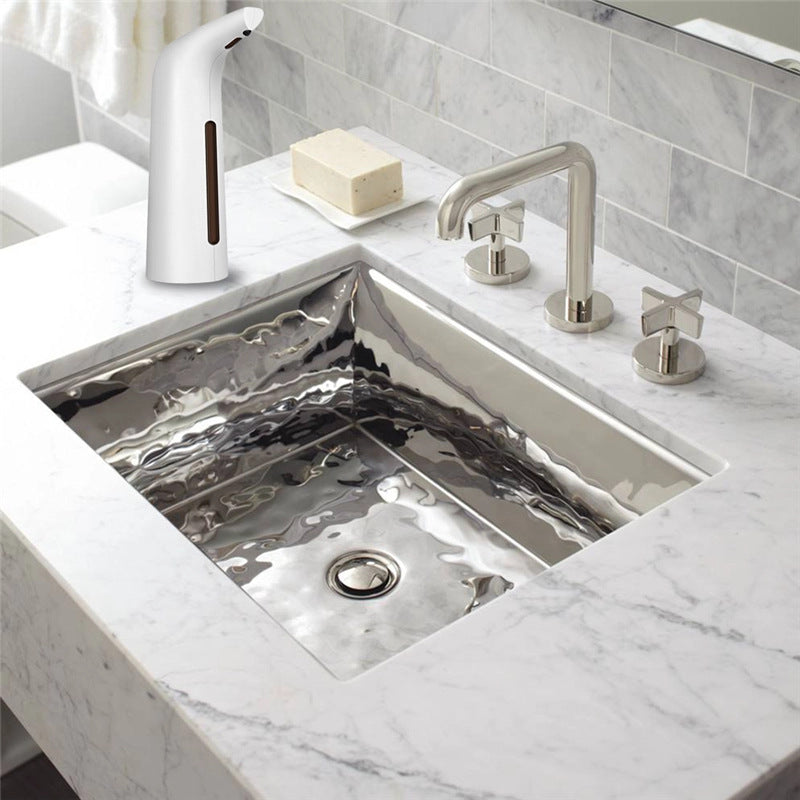 Modern kitchen sink with faucet and soap dispenser on a marble countertop