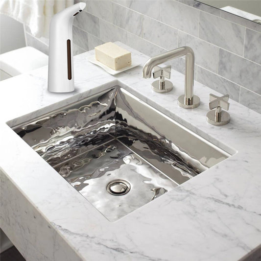 Modern kitchen sink with faucet and soap dispenser on a marble countertop