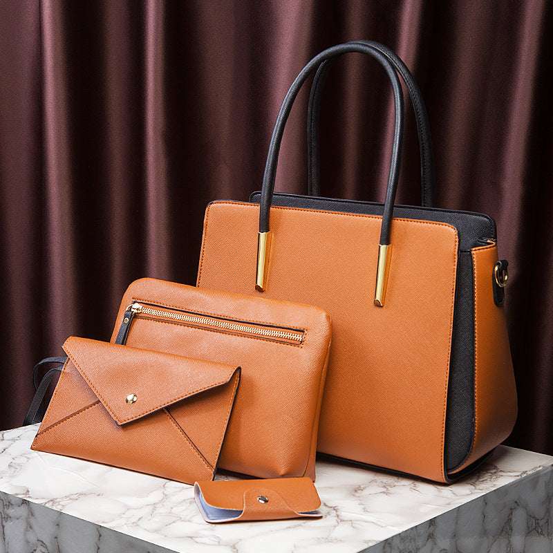 Large tan-orange handbag with navy trim, with envelope wallet and small pouch