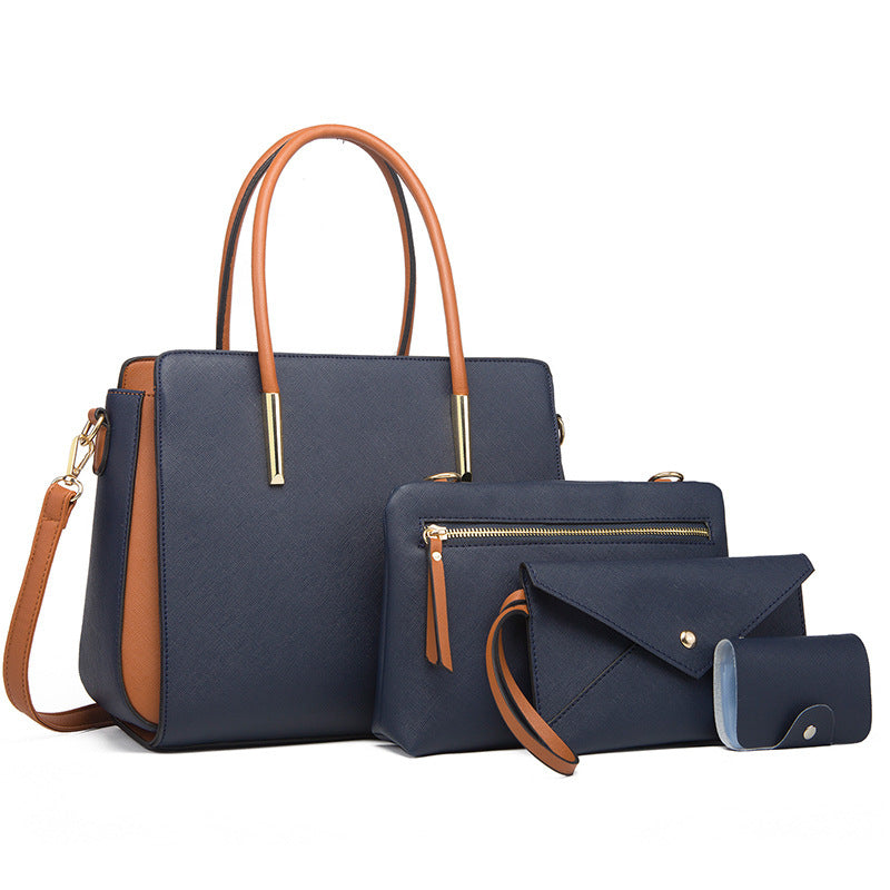 Large navy handbag with tan handles and crossbody strap, with pouch and wallet