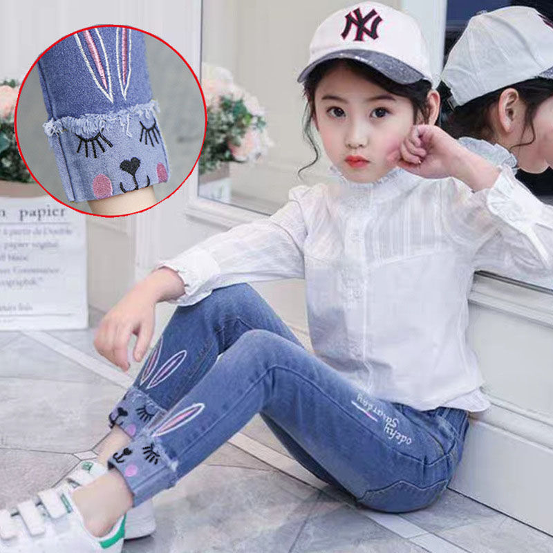 Girls' loose jeans pants in blue with elastic cuff and rabbit-face embroidery detail