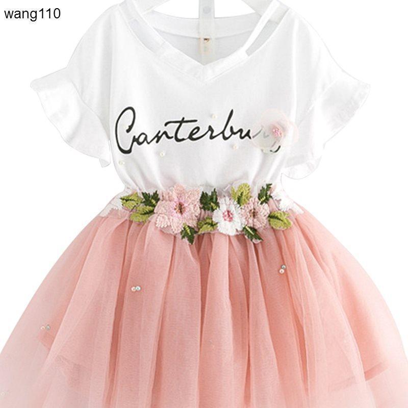 Girls' white T-shirt with script logo; peach-pink tulle skirt with floral waist detail