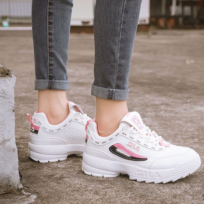 White chunky sneakers with pink and red accents, rear side view