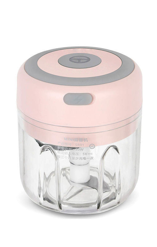 Electric garlic chopper with light pink lid and clear bowl, visible internal blades
