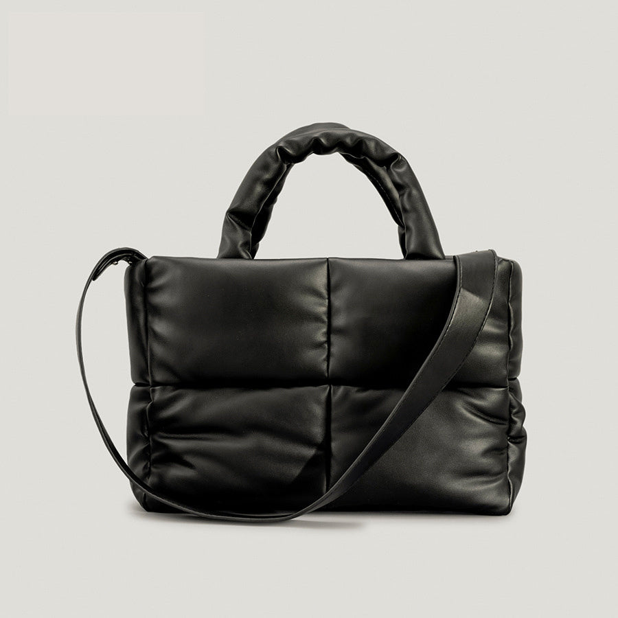 Puffer one-shoulder handbag in black with padded top handle and crossbody strap