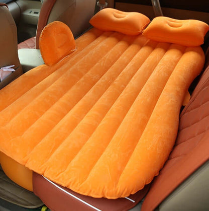 Orange ribbed inflatable car mattress with two raised pillows