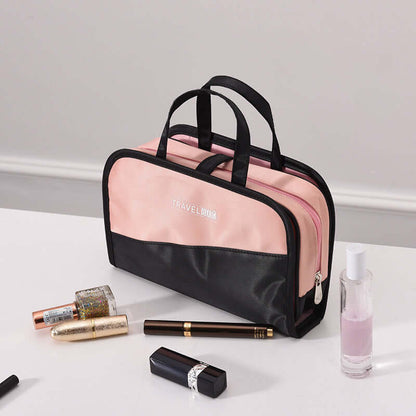 Cosmetic storage bag with pink front panel, black top handle, and zipper closure.