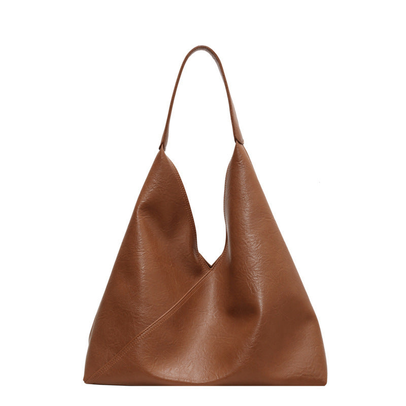 Tan-brown slouchy shoulder bag with wide U-shaped opening and top handles