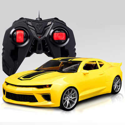 RC racing car model in yellow with remote controller, angled front view