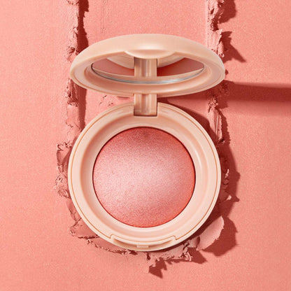 Powder blush compact with rose-pink shimmer powder over textured clay.