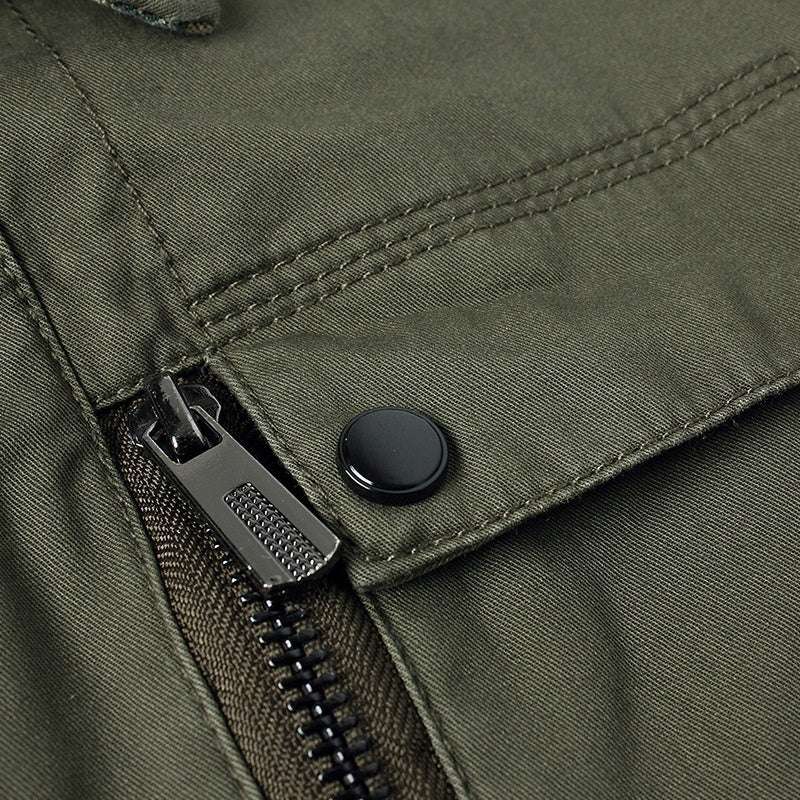 Close-up of a green jacket zipper and button