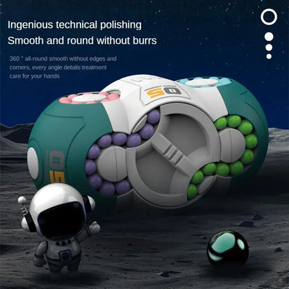 Rotating fidget cube toy with gray center and purple, green, and teal bead rings