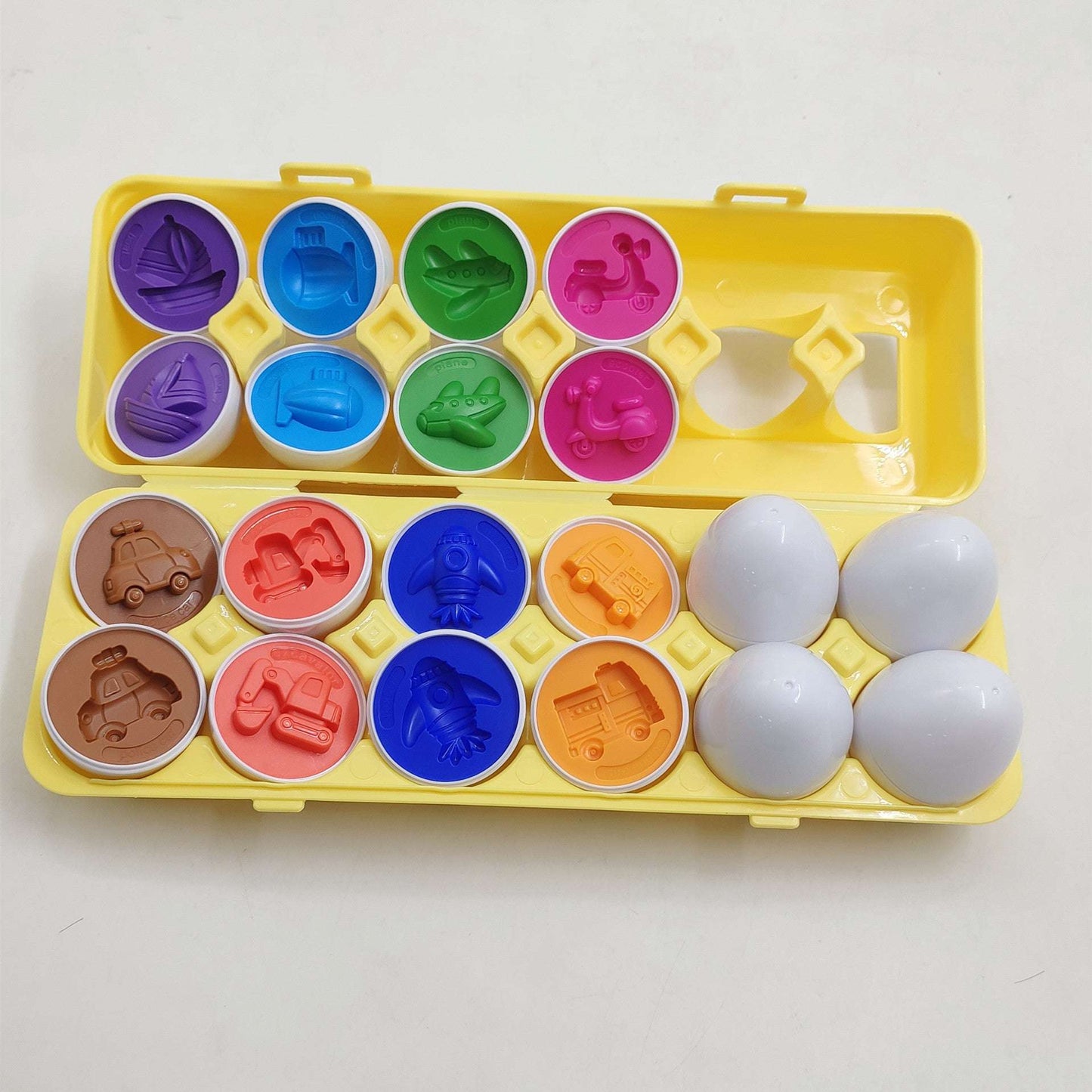 Colorful mold set with various shapes on a yellow tray against a white background