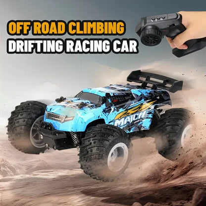 Blue off-road RC toy truck with remote controller and hand, kicking up dust