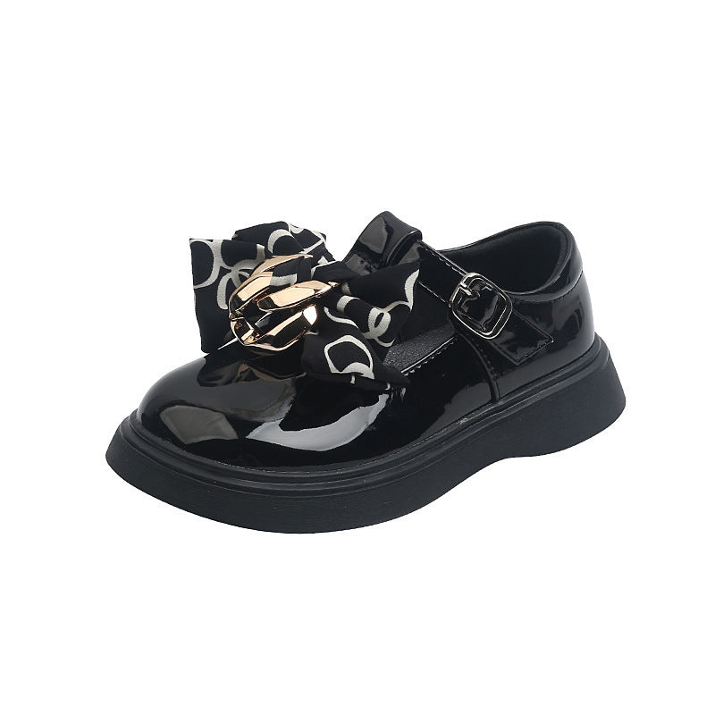 Girls' black leather sneaker-style shoe with shiny ribbon bow and buckled strap