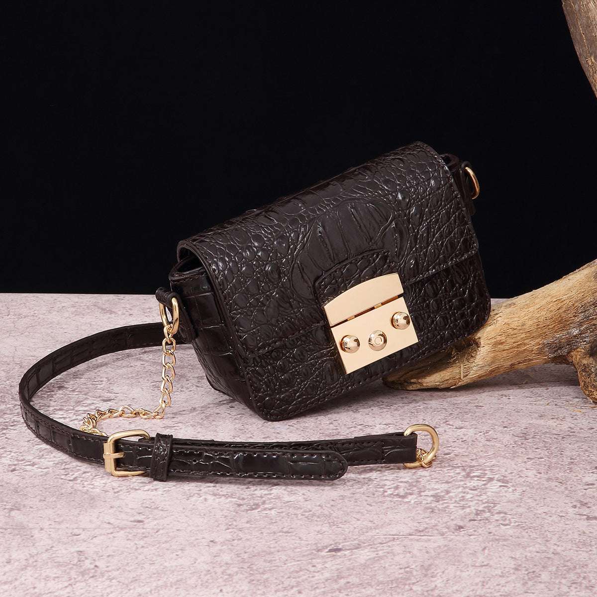 Dark brown croc-textured crossbody bag with flap, gold-tone lock, and chain strap