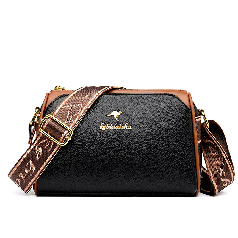 Black textured leather shoulder messenger bag with gold buckle and patterned strap
