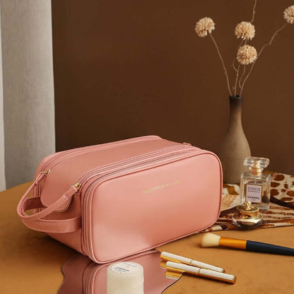 Light pink cosmetic bag with double zippers and a short crossbody strap