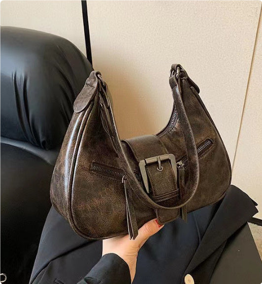 Dark taupe one-shoulder underarm bag with front buckle strap and zip detailing