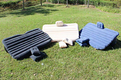 Inflatable car mattress set with dark gray, white, and light blue options on grass