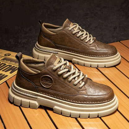 Brown leather sneakers with white soles on a wooden floor