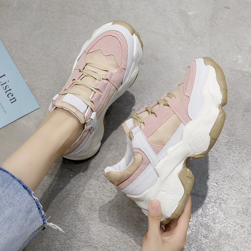 Women’s pink and white sneakers with beige accents, lace-up straps, and thick sole