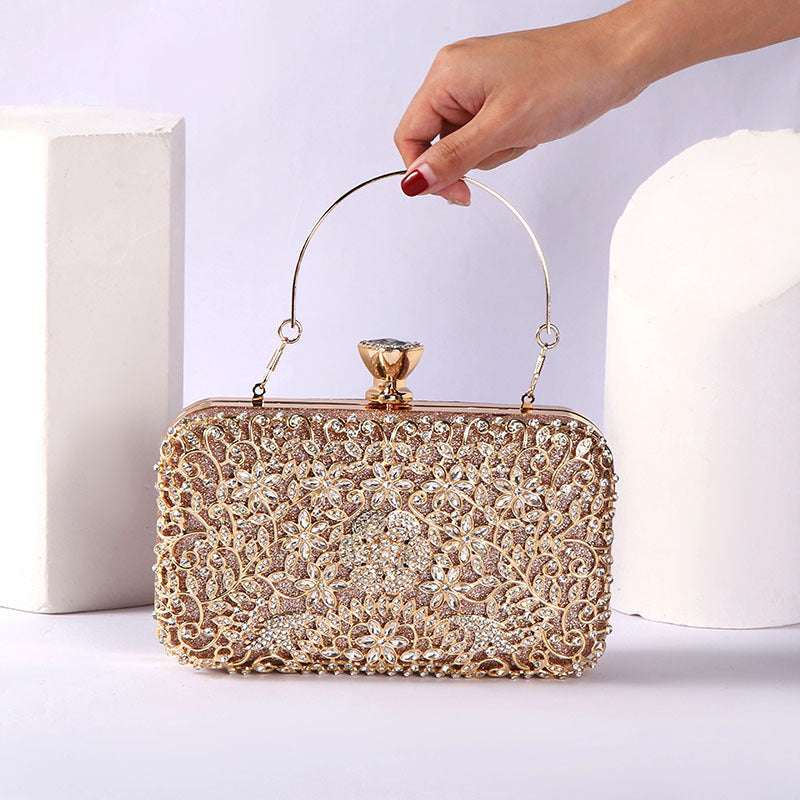 Gold rhinestone evening handbag held by a curved handle with frame clasp