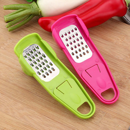 Light green and pink manual garlic mashers with grater plates and U-shaped handles