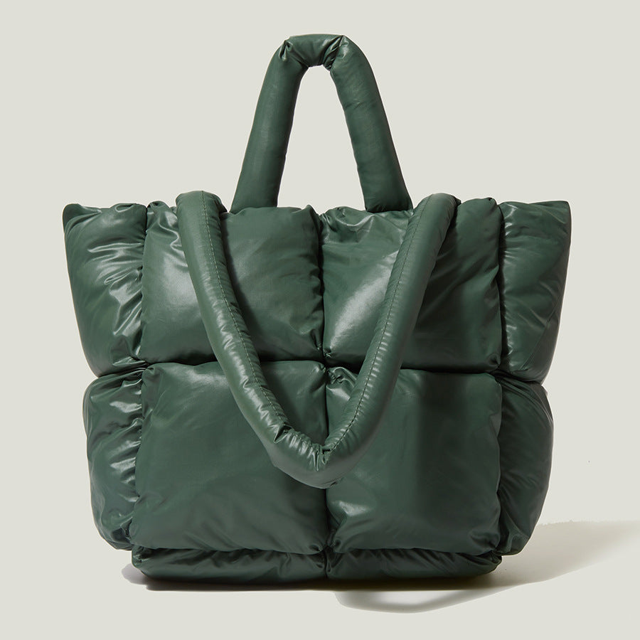 Dark green puffer tote handbag with two top handles and quilted front panels