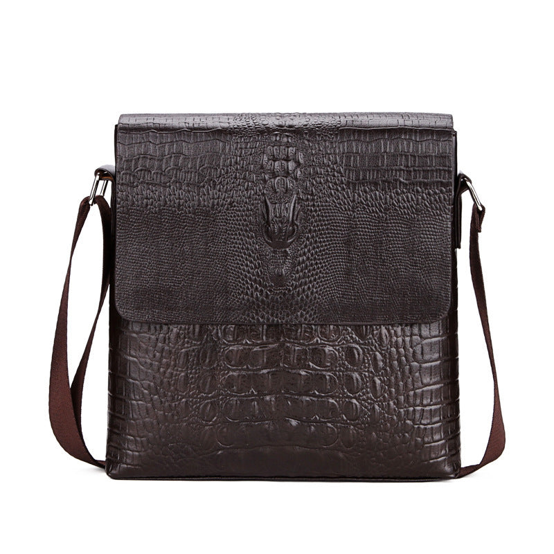 Leather crossbody bag with flap closure, embossed texture, and side straps