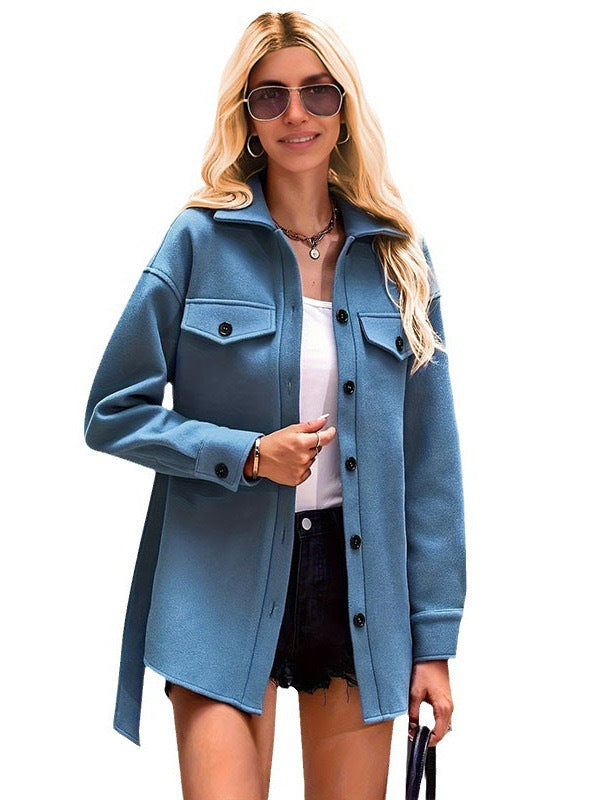 Woman wearing a blue coat on a white background