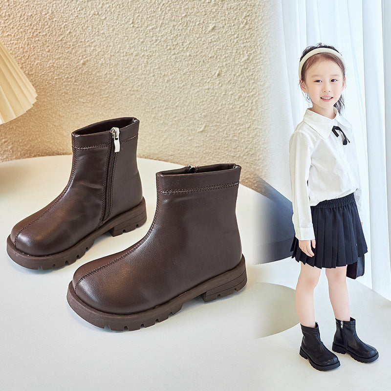 Kids' soft-soled Martin boots in dark brown with side zipper and tread sole.