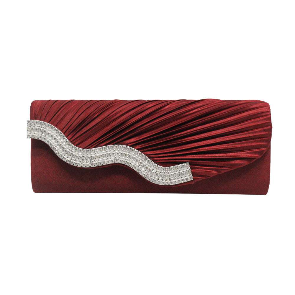 Burgundy pleated clutch with silver rhinestone wave ornament across the flap