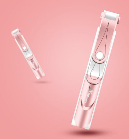 Pink nail clipper on a pink background