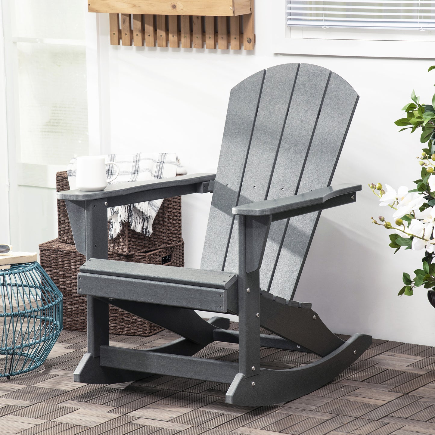 Light gray Adirondack rocking chair with slatted back, armrests, and rocking base