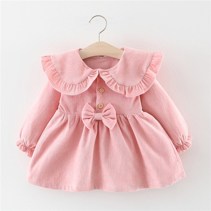 Baby girl dress in light pink with button front, bow at waist, and ruffled collar