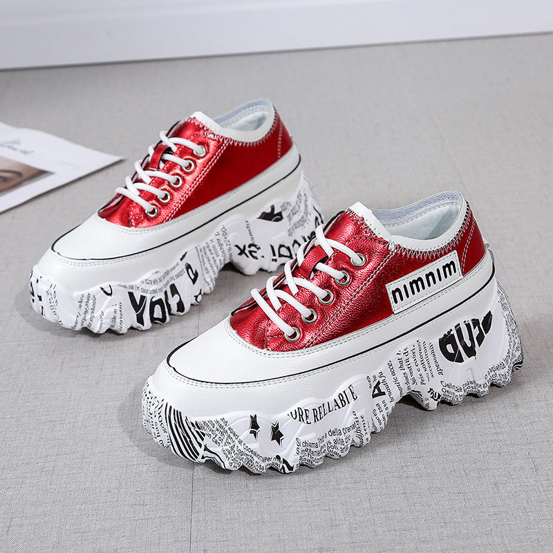 Red platform sneakers with lace-up front and printed chunky sole, side view pair