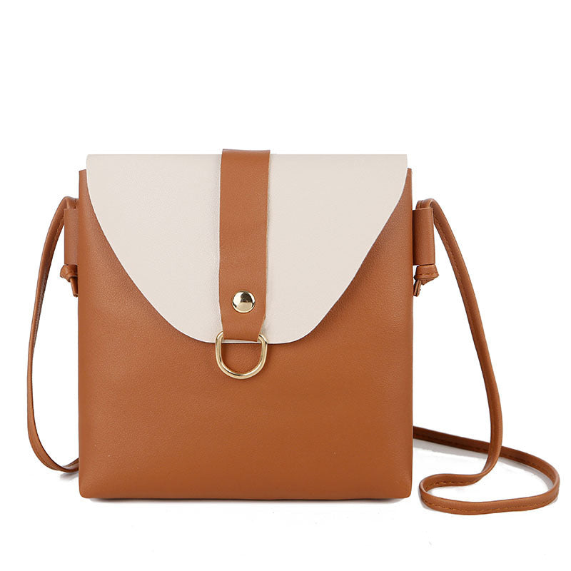 Light brown messenger bag with white flap, gold ring, and crossbody strap