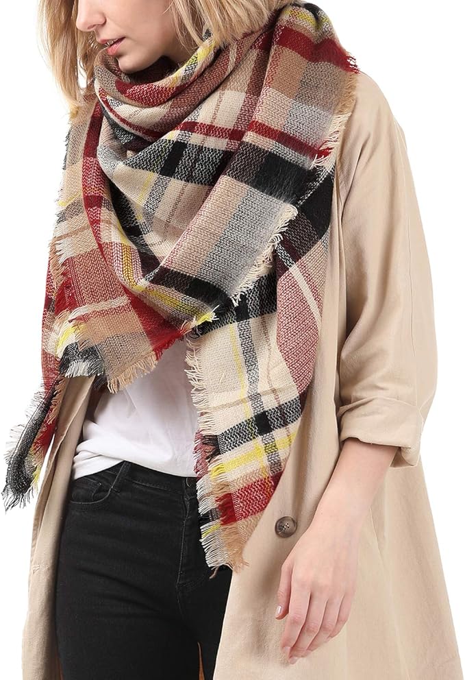 Multicolor plaid scarf with fringed ends, worn as a shawl wrap.