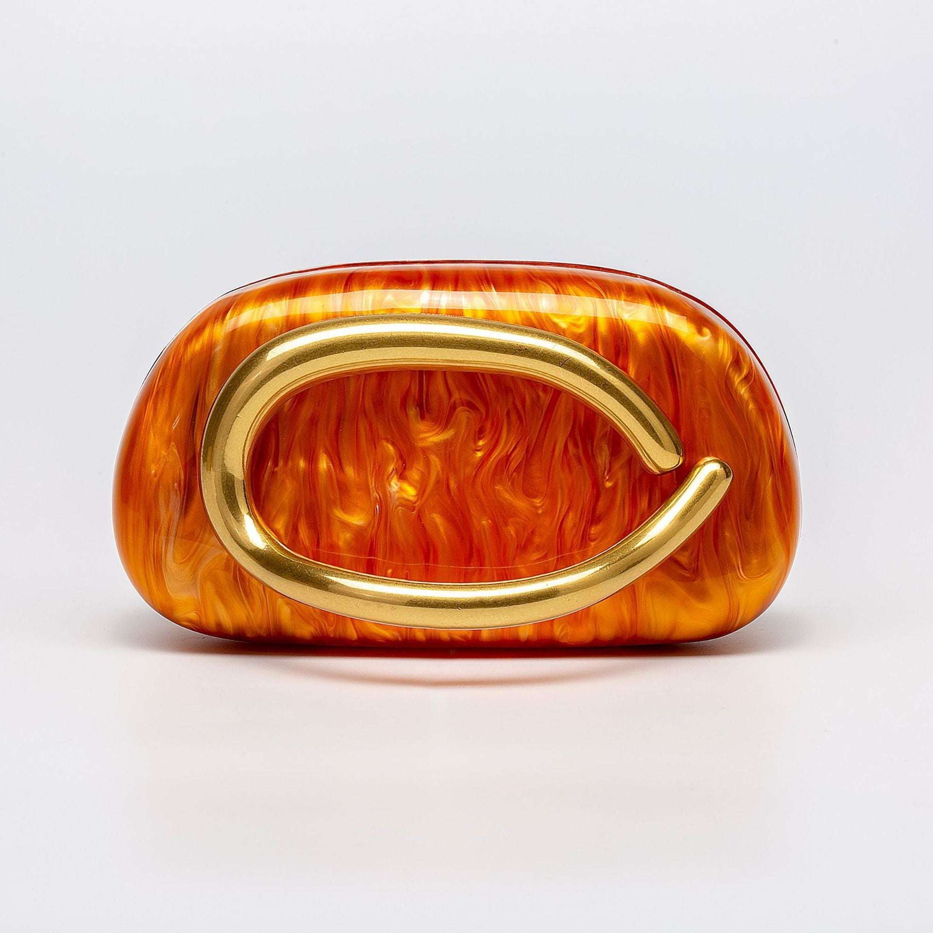 Orange acrylic dinner clutch with oval gold clasp and short handle strap