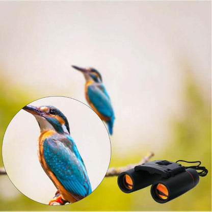Black binoculars with orange objective lenses and carrying cord