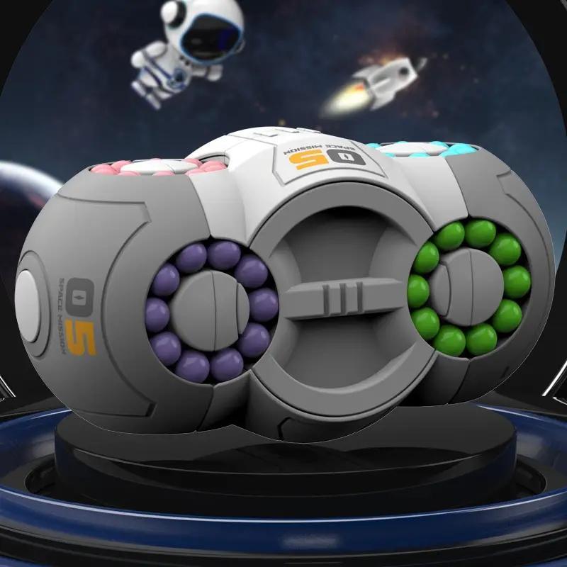 Rotating magic bean cube fidget toy with grey center, purple and green bead rings, cyan top
