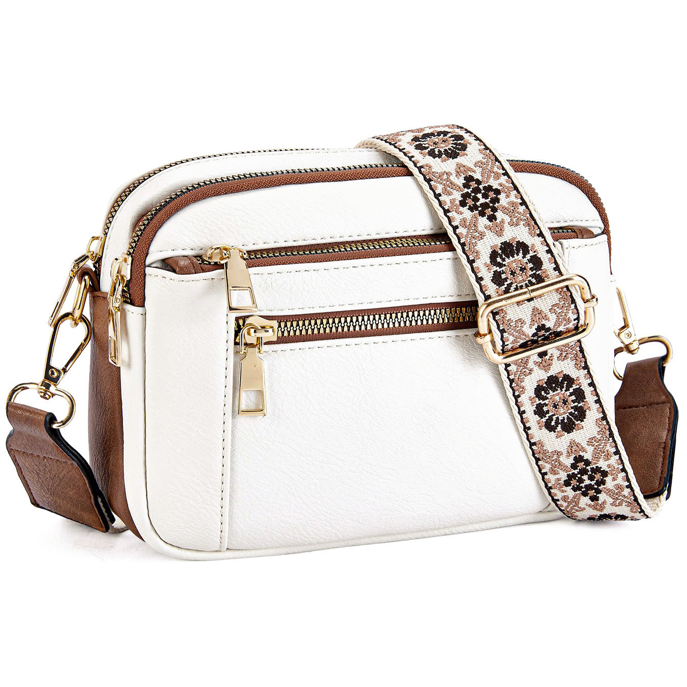 White triple-zip crossbody bag with brown trim, floral patterned strap, and gold hardware