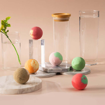Bath bomb set with multiple spheres in green, pink, red, orange, and beige on display