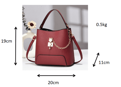 Red PU leather bucket bag with top handle, shoulder strap, and front chain charm
