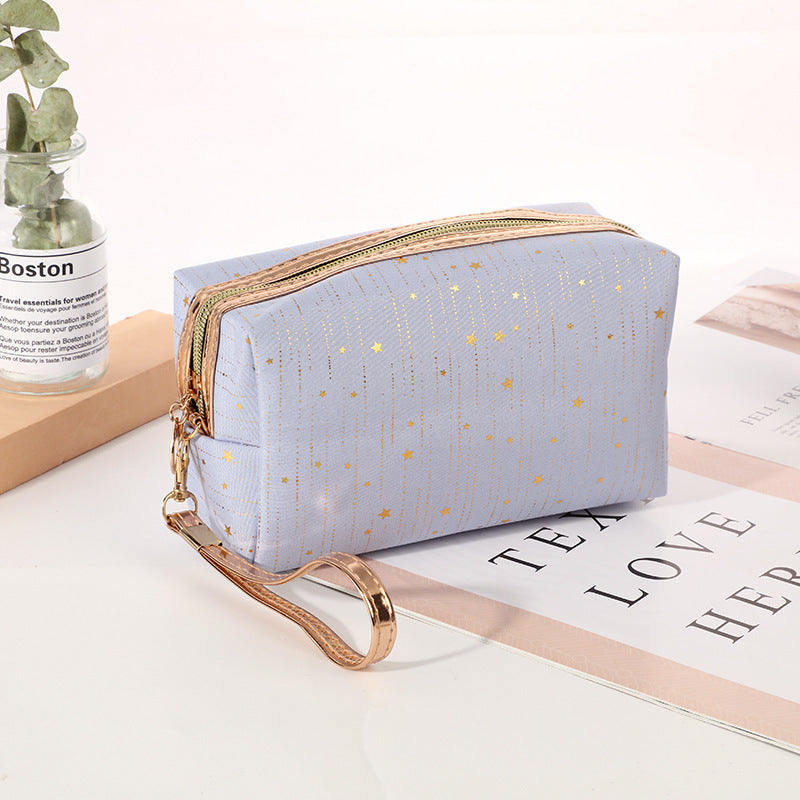 Light blue octagonal star cosmetic bag with gold zipper and wrist strap